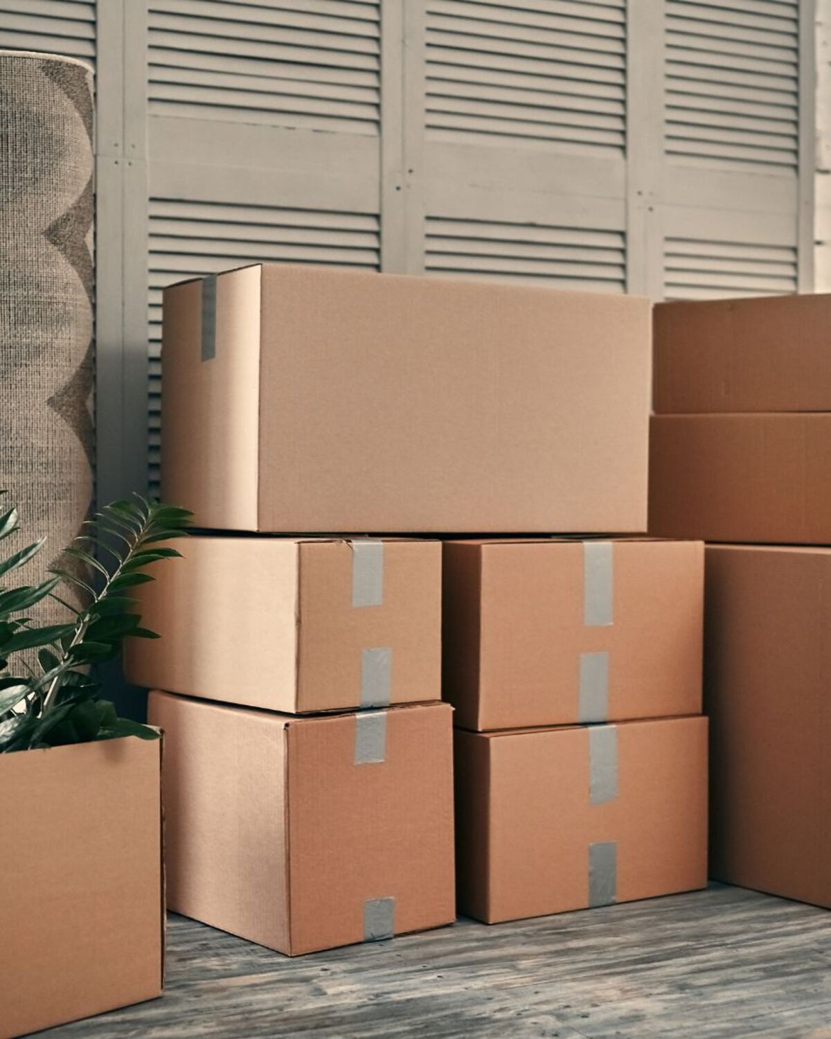 Neatly stacked boxes in a commercial space with large windows