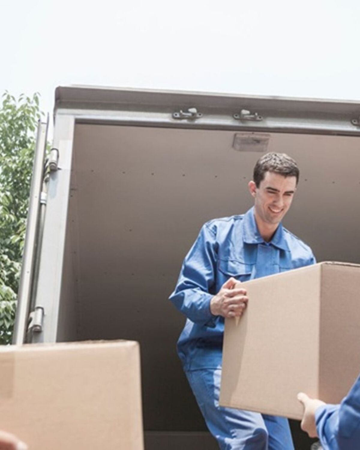Moving crew passing boxes into a truck during a local Rutland move