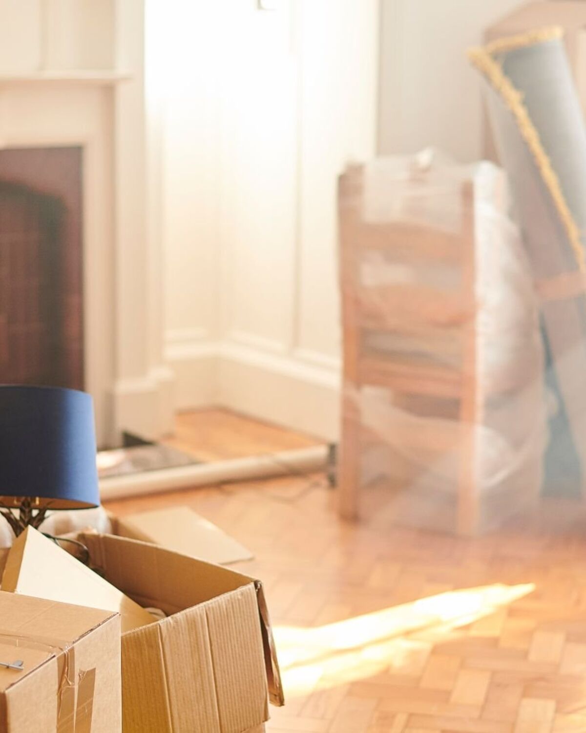 Furniture wrapped and protected in a living room mid-move