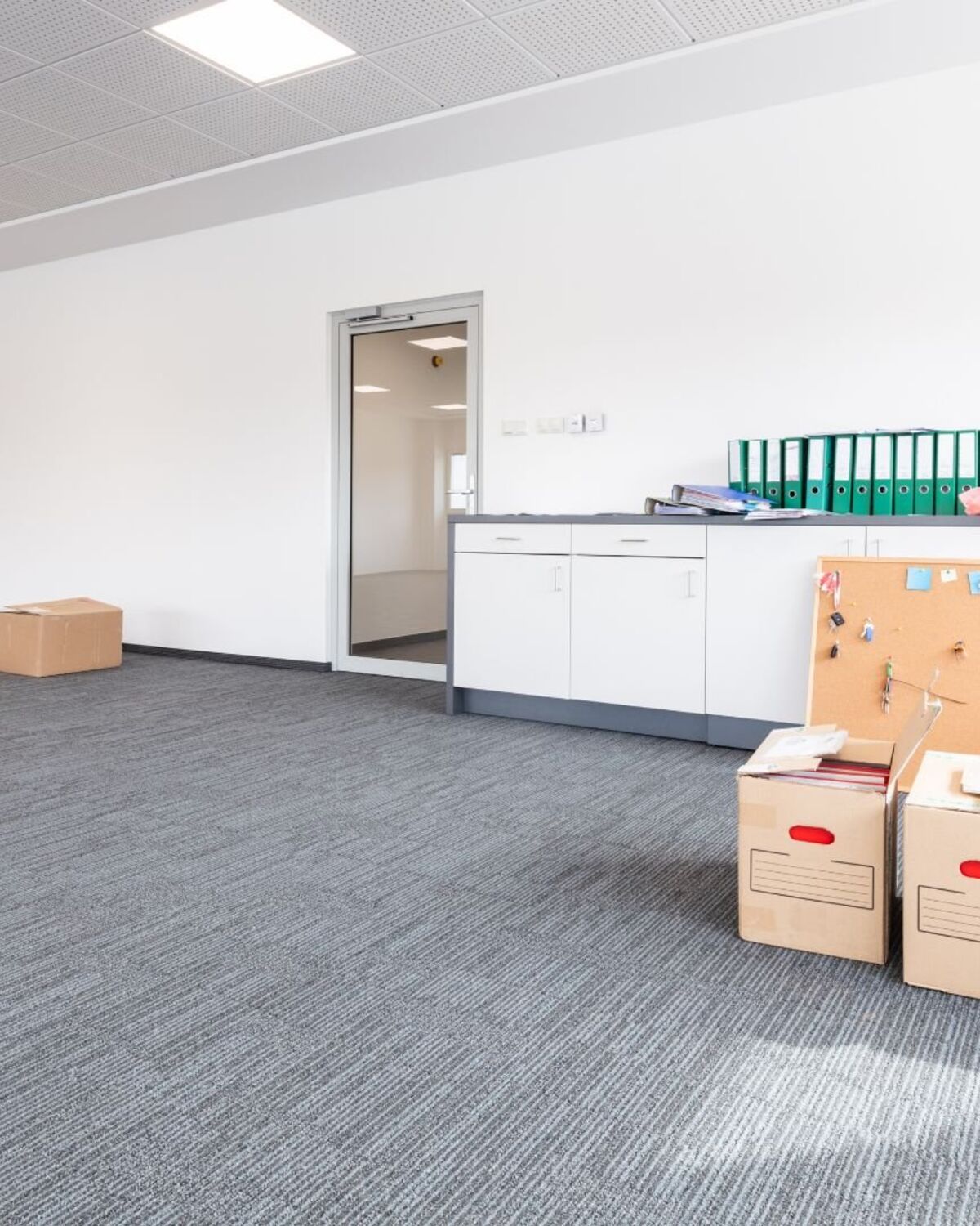 File boxes and binders staged in an emptied office suite