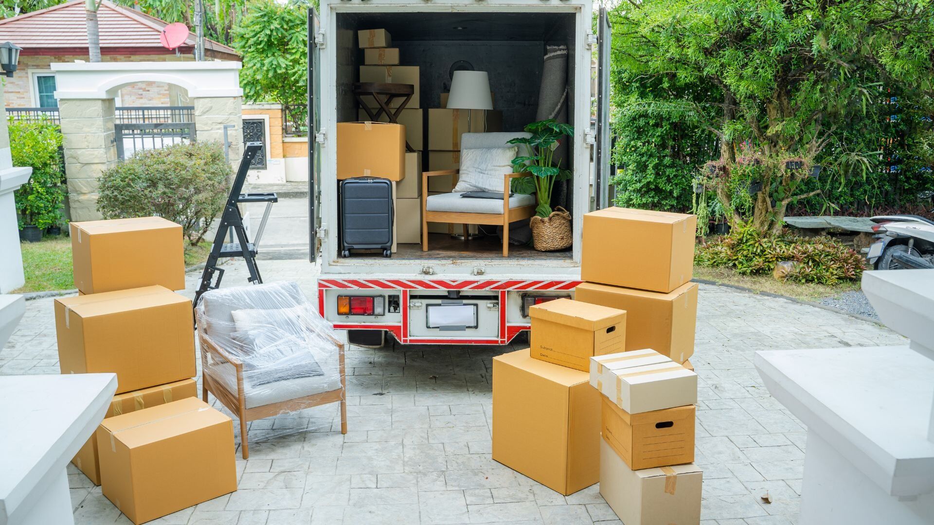 Moving truck open in the driveway of a Vermont home